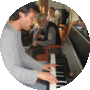 Playing piano at home, with his father, Arie, on guitar